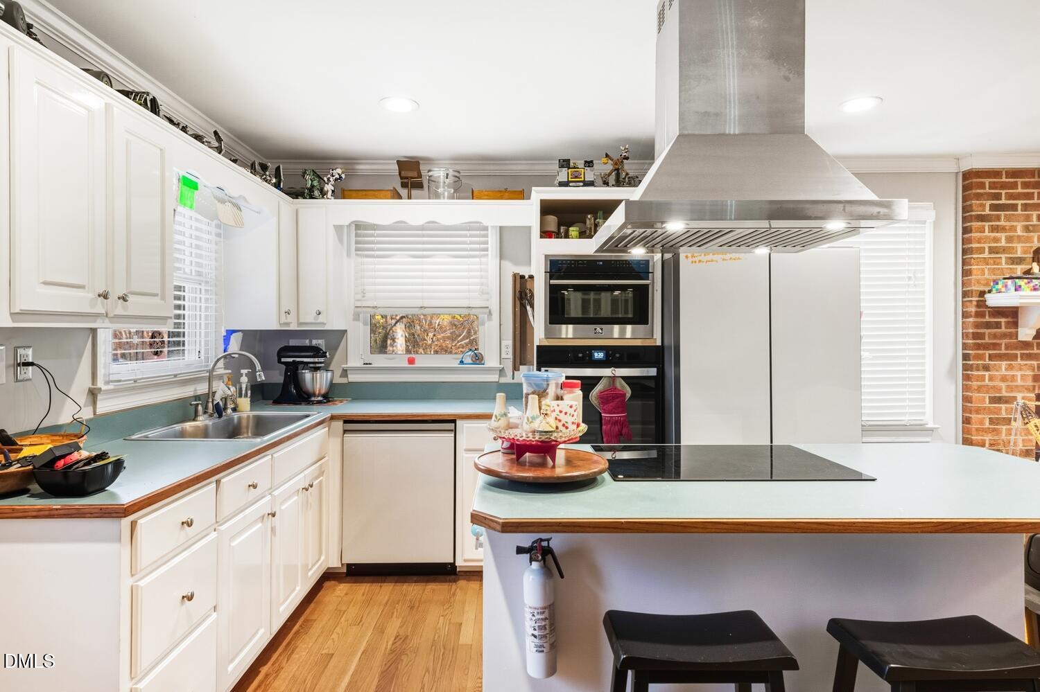 2961 Wormranch Road Haw River, NC 27258 - Photo 16 of 27 a kitchen with stainless steel appliances a sink a stove and white cabinets