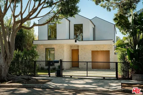 a front view of a house with a street