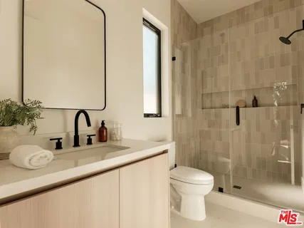 a bedroom with a bed and a night stand