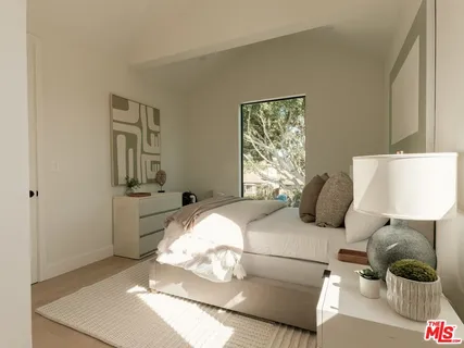 a bedroom with a bed and a painting