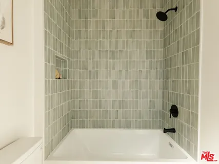 a bedroom with a bed and a lamp