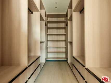 a bedroom with a bed and cabinets