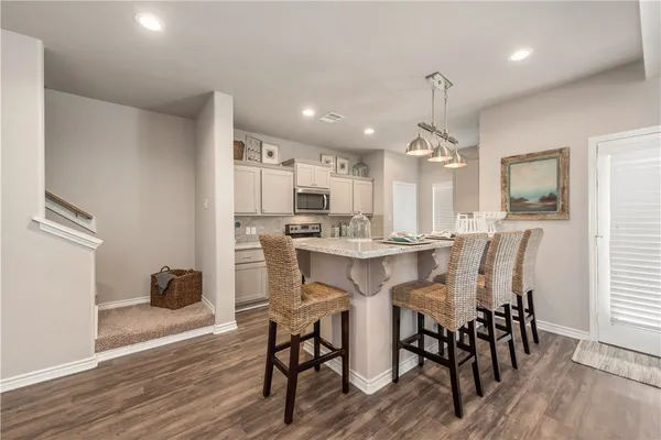 a dining room with furniture and wooden floor