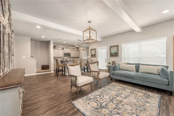 a living room with furniture and a chandelier
