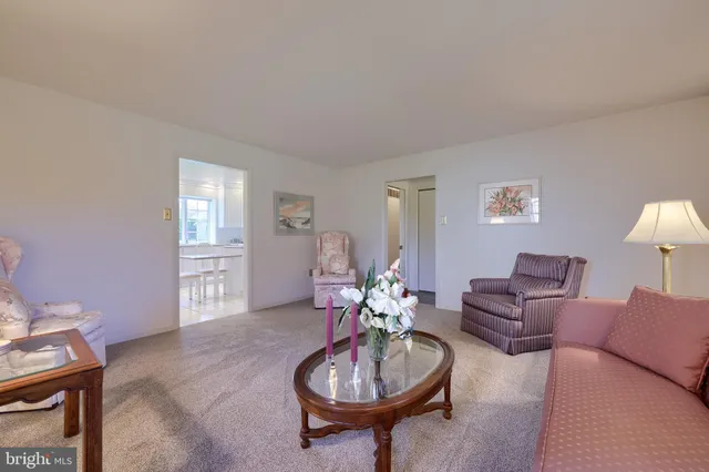 a living room with furniture a window and a lamp