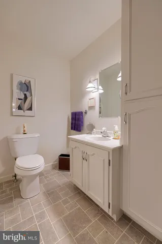 a spacious bathroom with a toilet sink and mirror