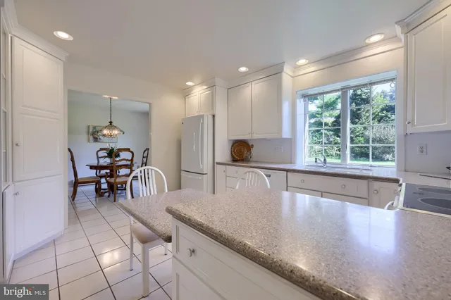 a kitchen with granite countertop sink and cabinets