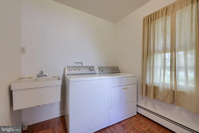 a utility room with cabinets washer and dryer