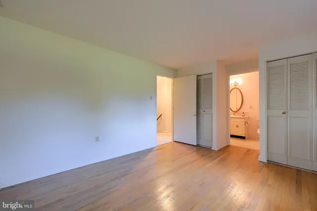 a view of an empty room and wooden floor