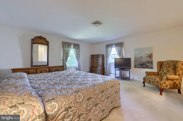 a bedroom with a bed and a television in it