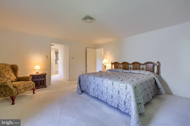 a spacious bedroom with a bed and a couch