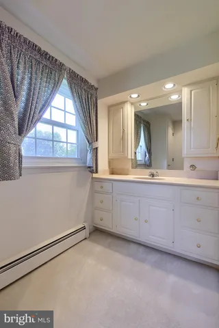a spacious bathroom with a double vanity sink and a mirror