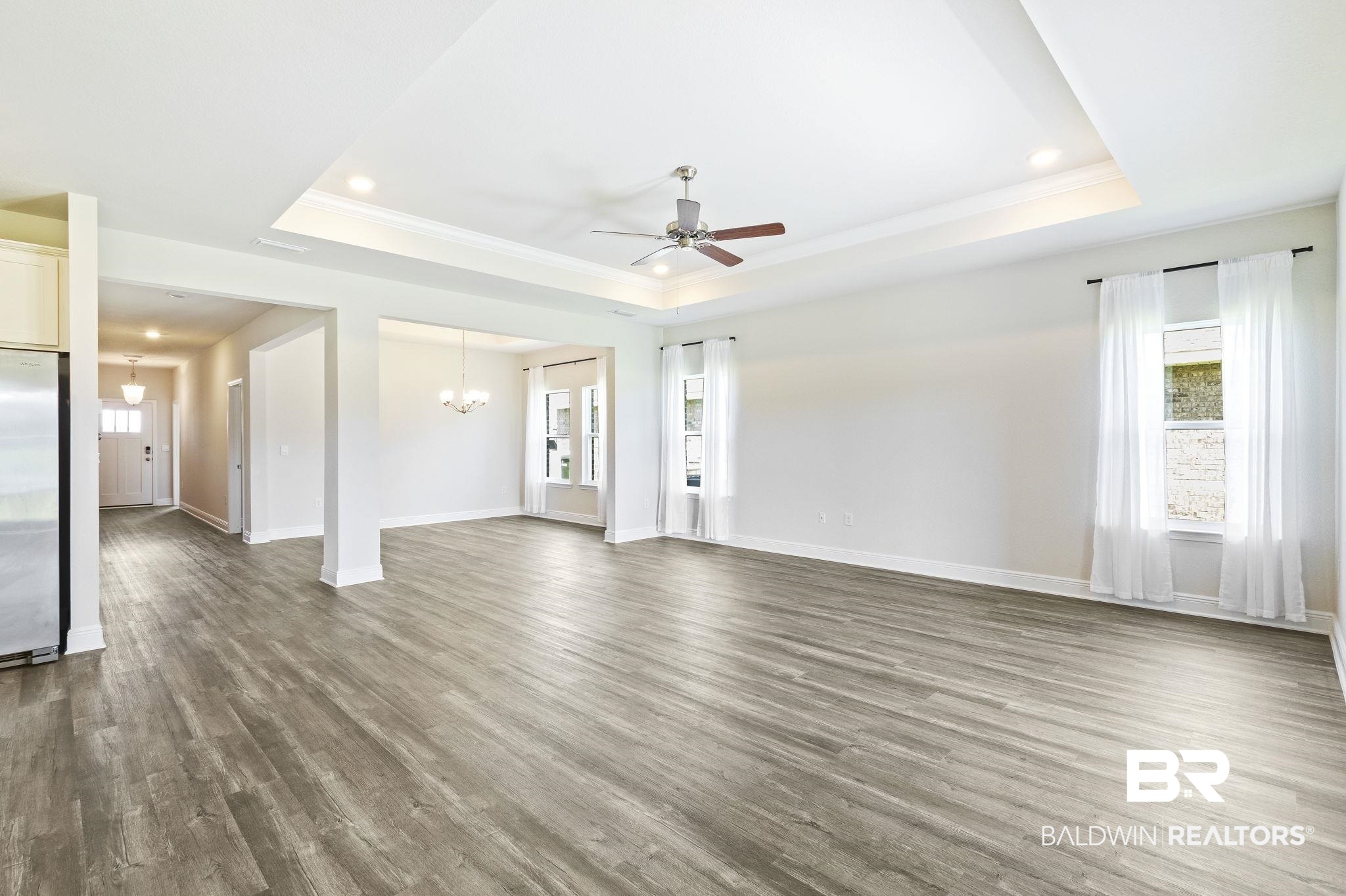 11303 Genuine Risk Circle Daphne, AL 36526 - Photo 14 of 100 Great room has a trey ceiling, crown molding and lots of natural light