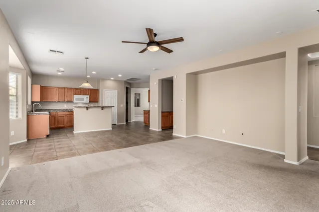a view of a kitchen with a sink and a refrigerator