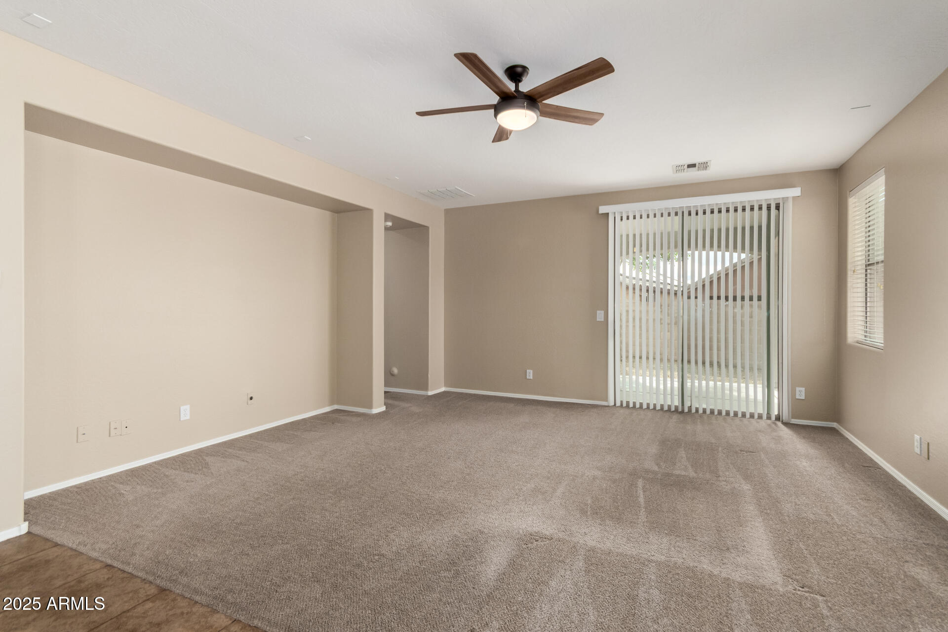 2203 West Vía Caballo Blanco Phoenix, AZ 85085 - Photo 15 of 28 an empty room with a ceiling fan and a window