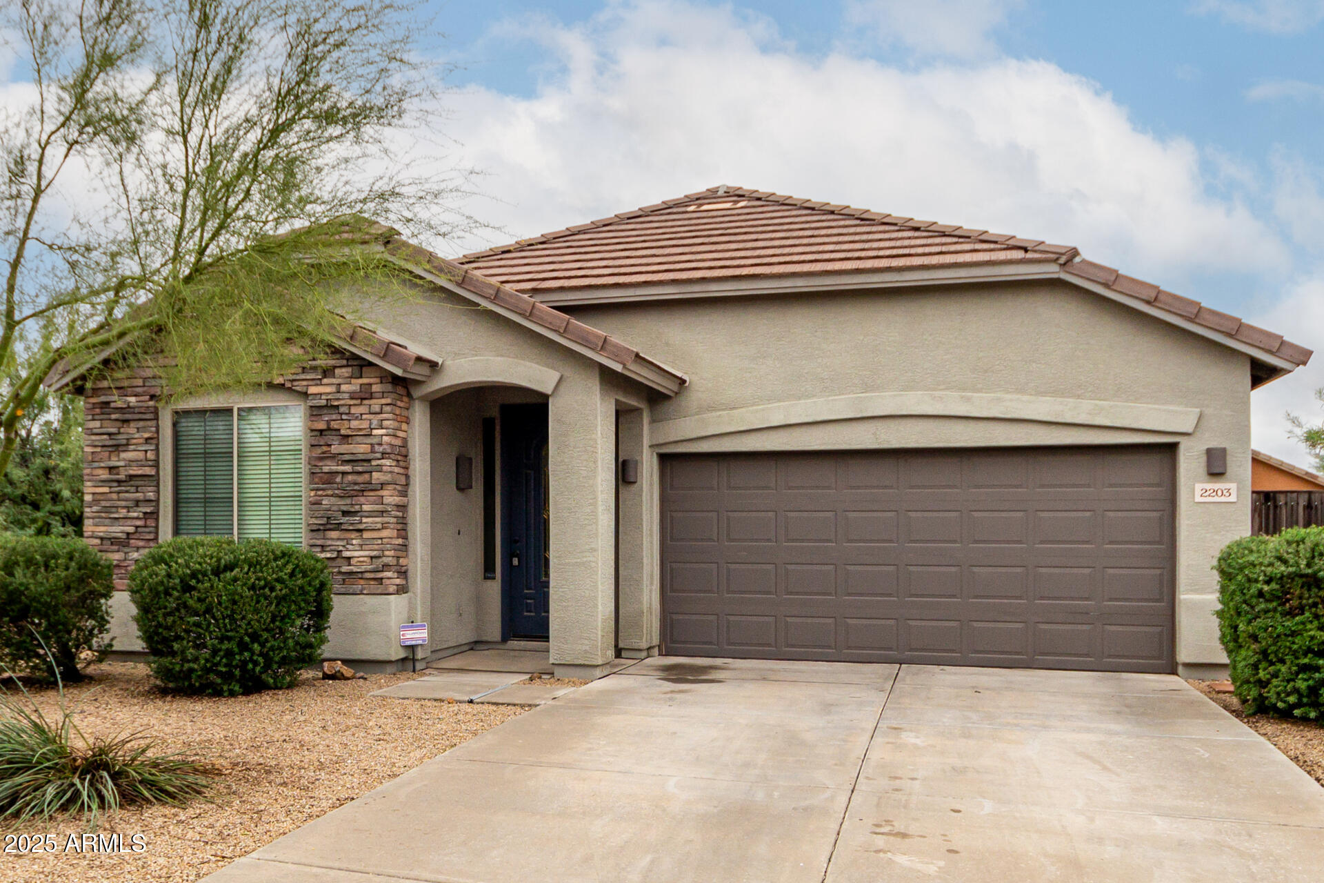 2203 West Vía Caballo Blanco Phoenix, AZ 85085 - Photo 2 of 28 a front view of a house with garage