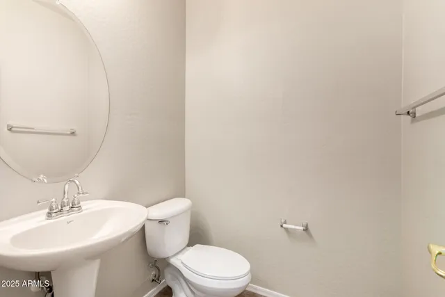 a bathroom with a sink a toilet and mirror