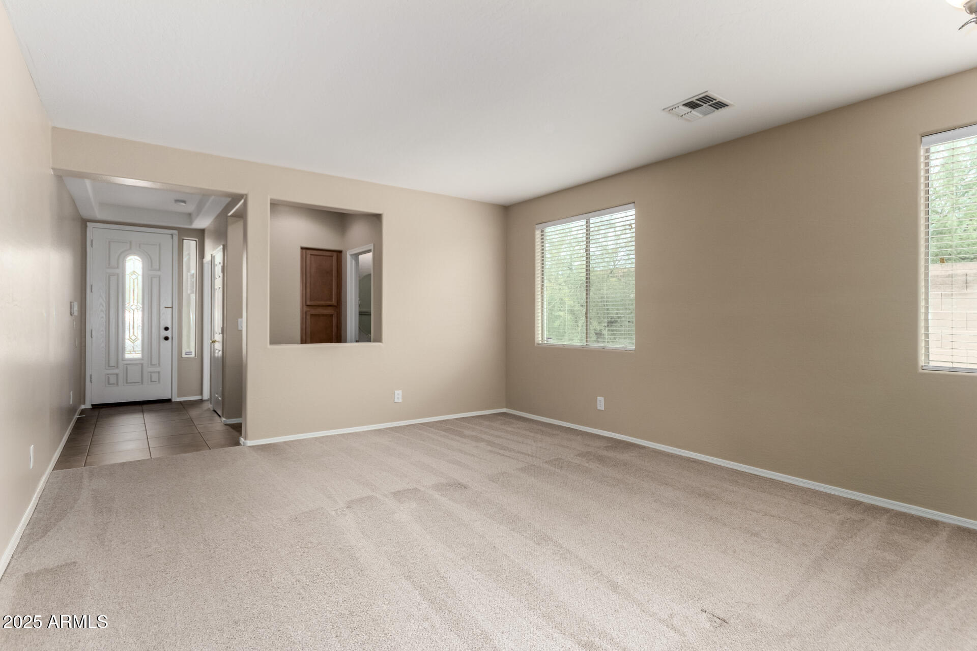 2203 West Vía Caballo Blanco Phoenix, AZ 85085 - Photo 7 of 28 an empty room with windows