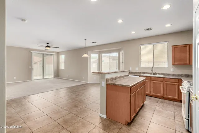a kitchen with a stove a sink and a refrigerator