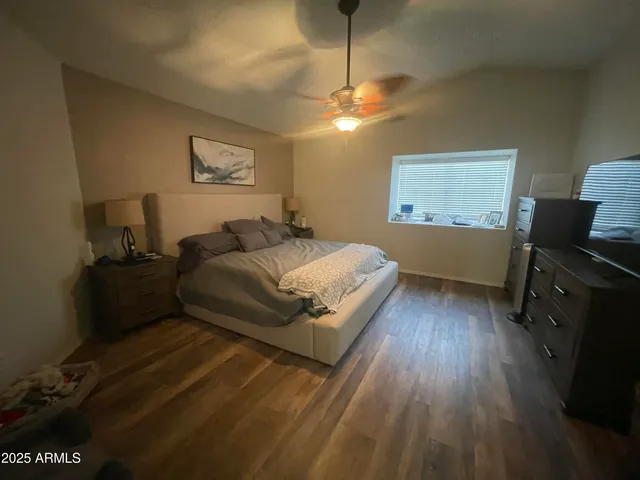 a spacious bedroom with a bed and a desk