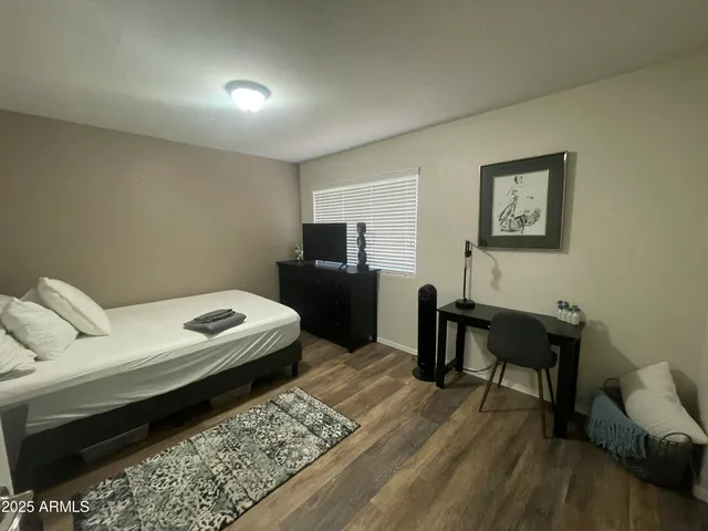 a bedroom with a bed and a table in it