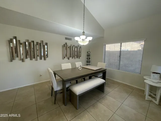 a dining room with furniture and window