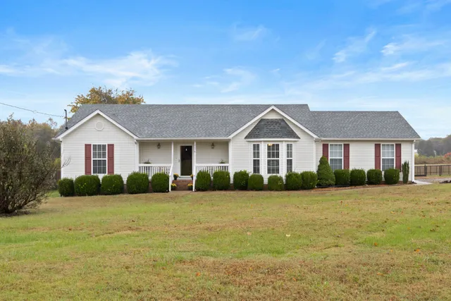 a front view of house with yard and green space