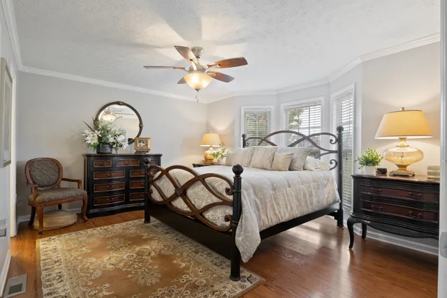 a bedroom with bed and a chandelier
