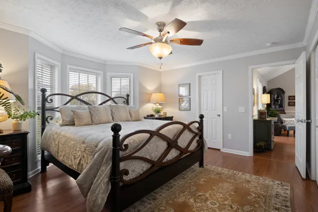 a bedroom with a bed and ceiling fan