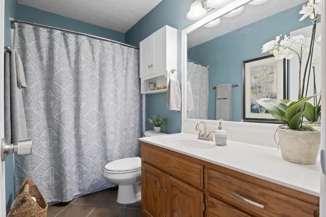 a bathroom with a sink a toilet and a mirror