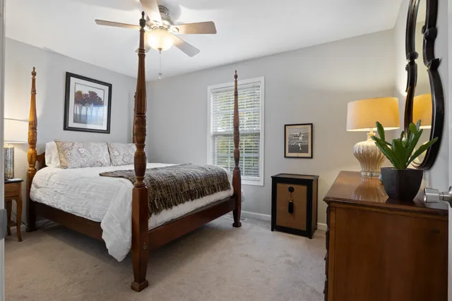 a bedroom with a bed dresser and a window