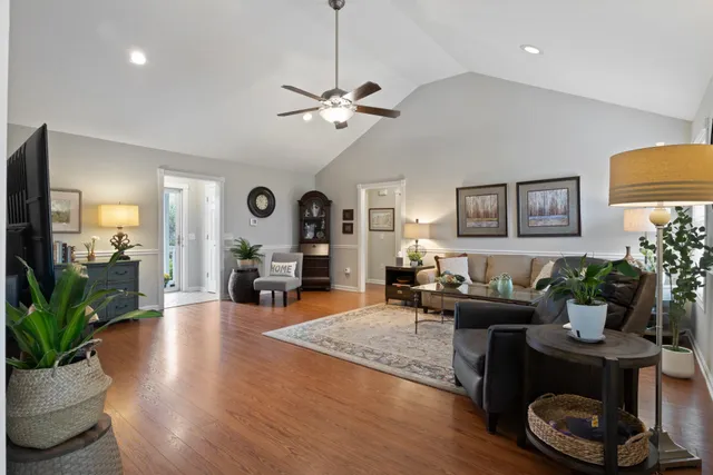 a living room with furniture potted plant and a chandelier