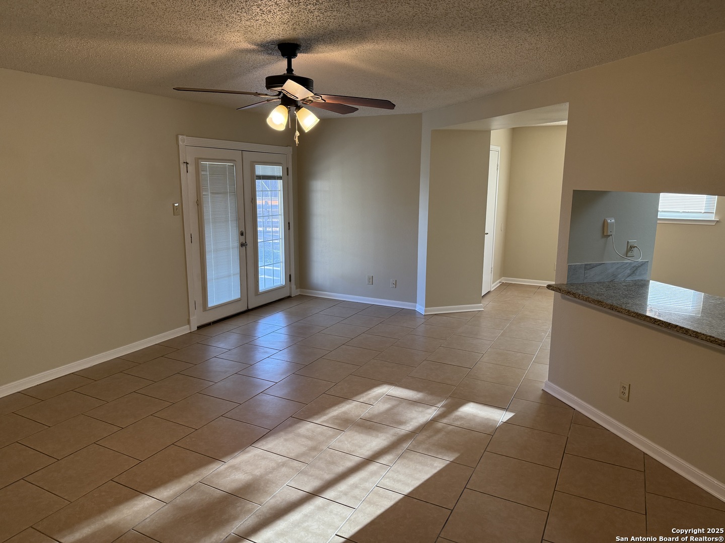 8015 Chestnut Gate Lane Converse, TX 78109 - Photo 13 of 21 a view of an empty room with window and wooden floor
