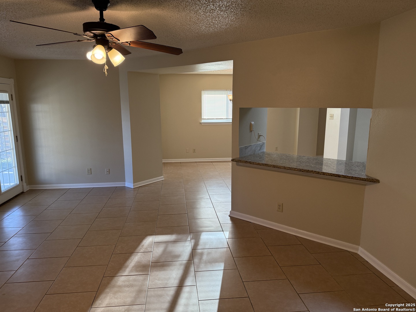 8015 Chestnut Gate Lane Converse, TX 78109 - Photo 14 of 21 a view of a livingroom with a ceiling fan and window