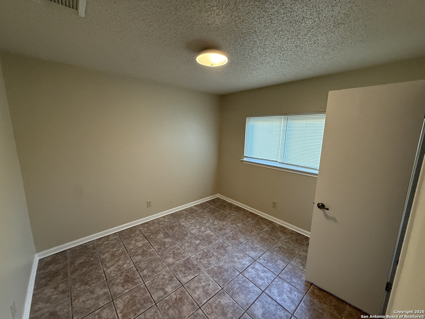 8015 Chestnut Gate Lane Converse, TX 78109 - Photo 17 of 21 an empty room with windows