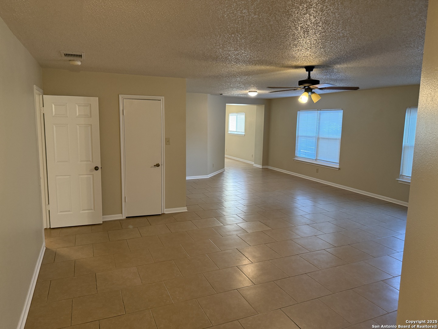 8015 Chestnut Gate Lane Converse, TX 78109 - Photo 3 of 21 a view of an empty room with window and wooden floor
