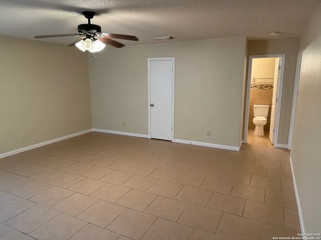 a view of a livingroom with a chandelier fan