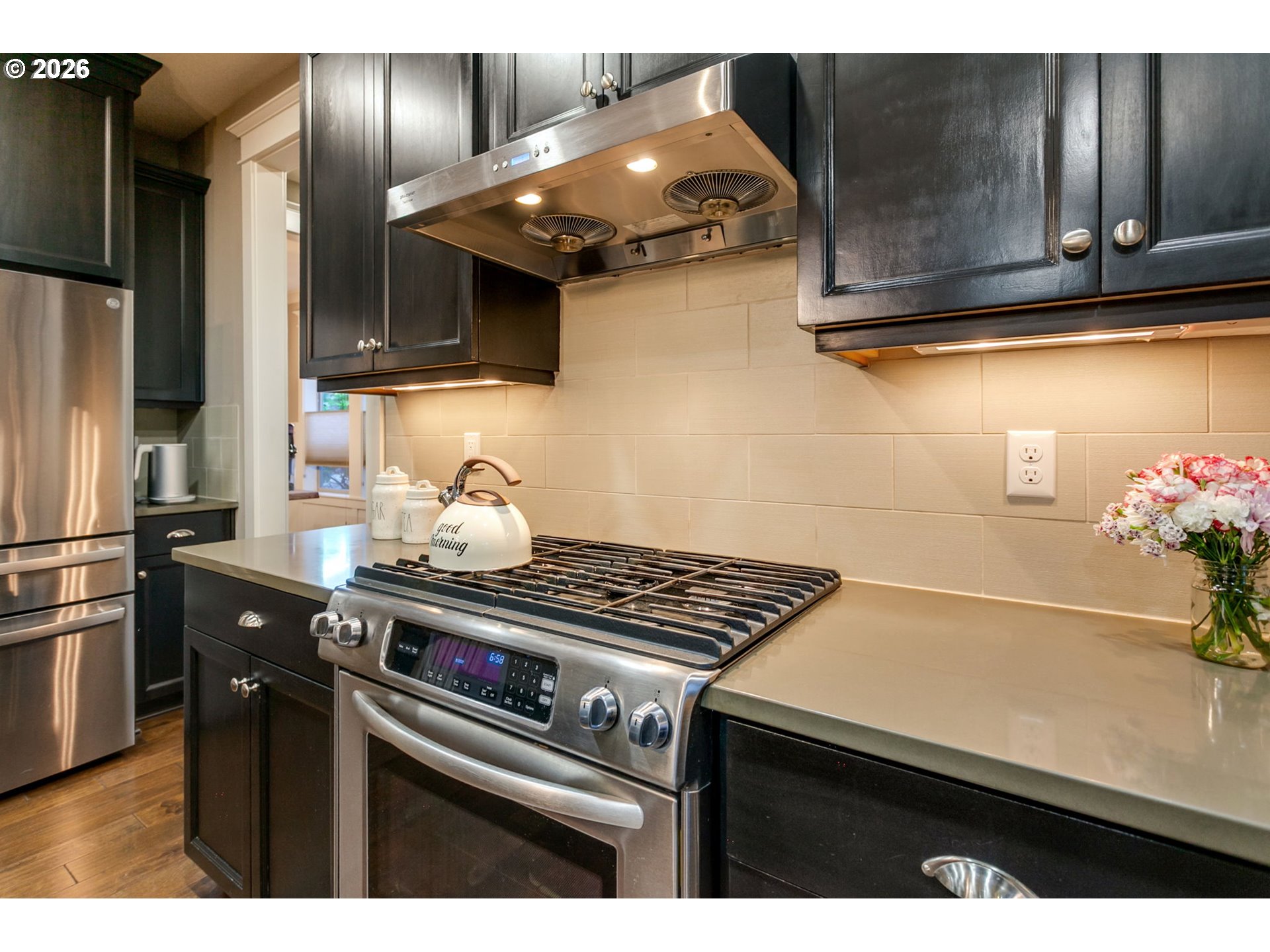14390 Southwest Fox Lane Beaverton, OR 97008 - Photo 17 of 47 a kitchen with stainless steel appliances a sink stove and refrigerator