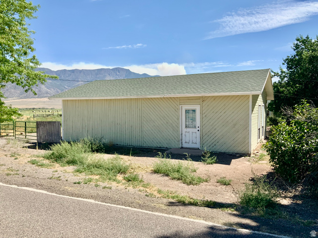 630 North Main Street Monroe, UT 84754 - Photo 43 of 63 View of shops exterior with a shingled roof and a mountain view