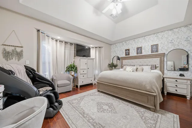 a bedroom with bed couch and window