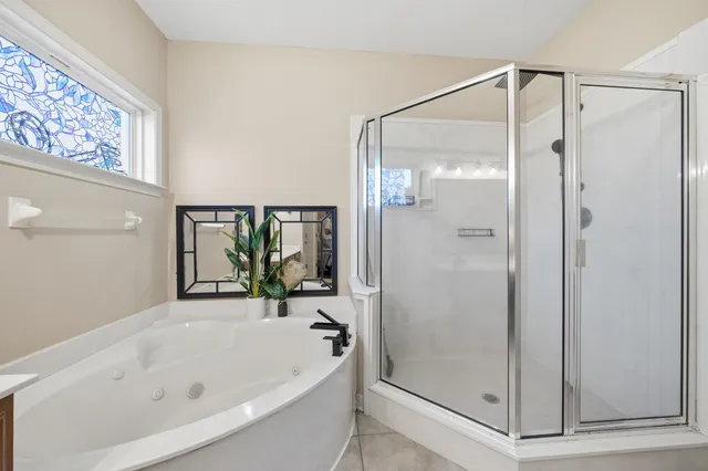 a bathroom with a bathtub and a shower