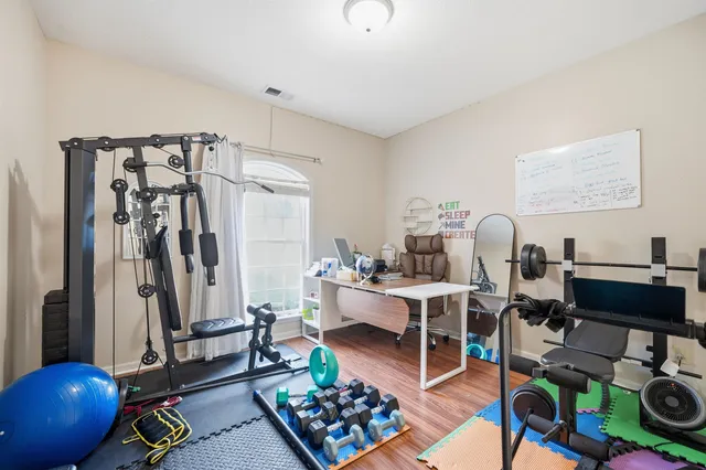 a living room with lots of furniture and gym equipment