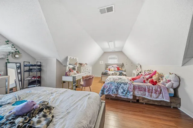 a bedroom with two beds and a closet