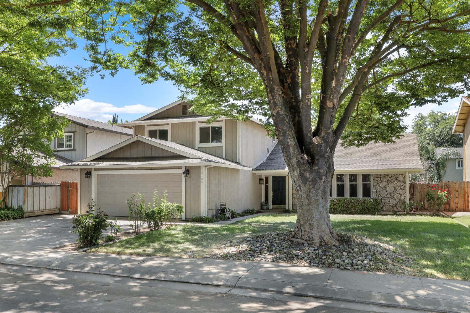 a front view of a house with a garden