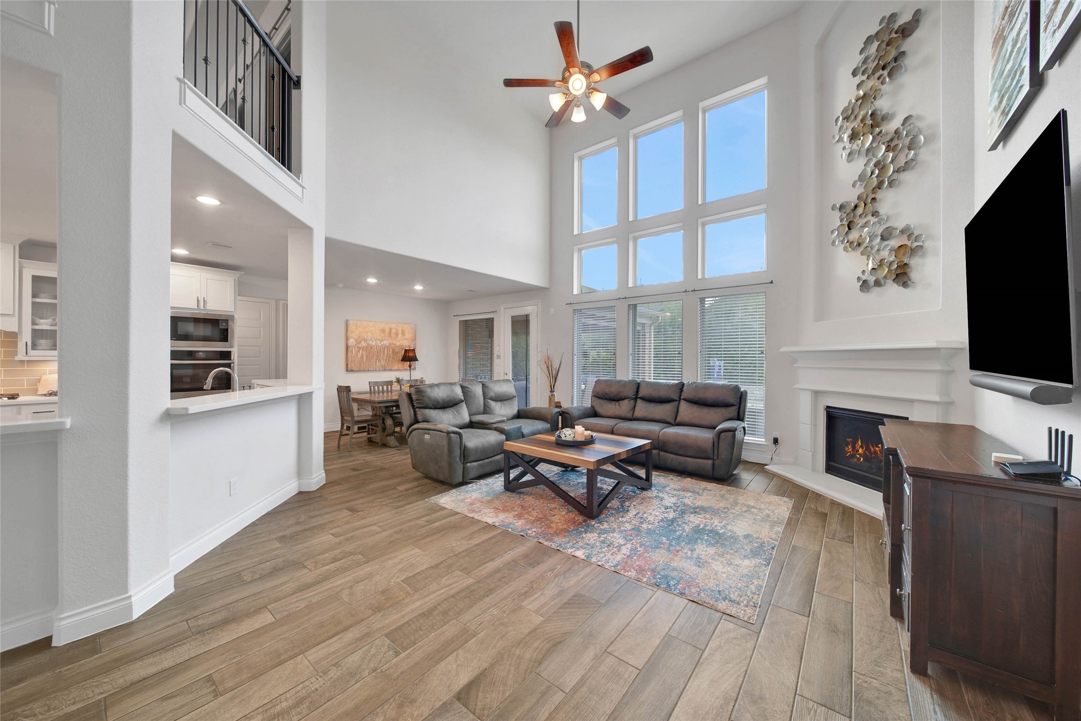 28602 Mountain Timber Court Fulshear, TX 77441 - Photo 14 of 47 Living Room boasts soaring ceilings with a back wall of windows offering tranquil views of the back yard.