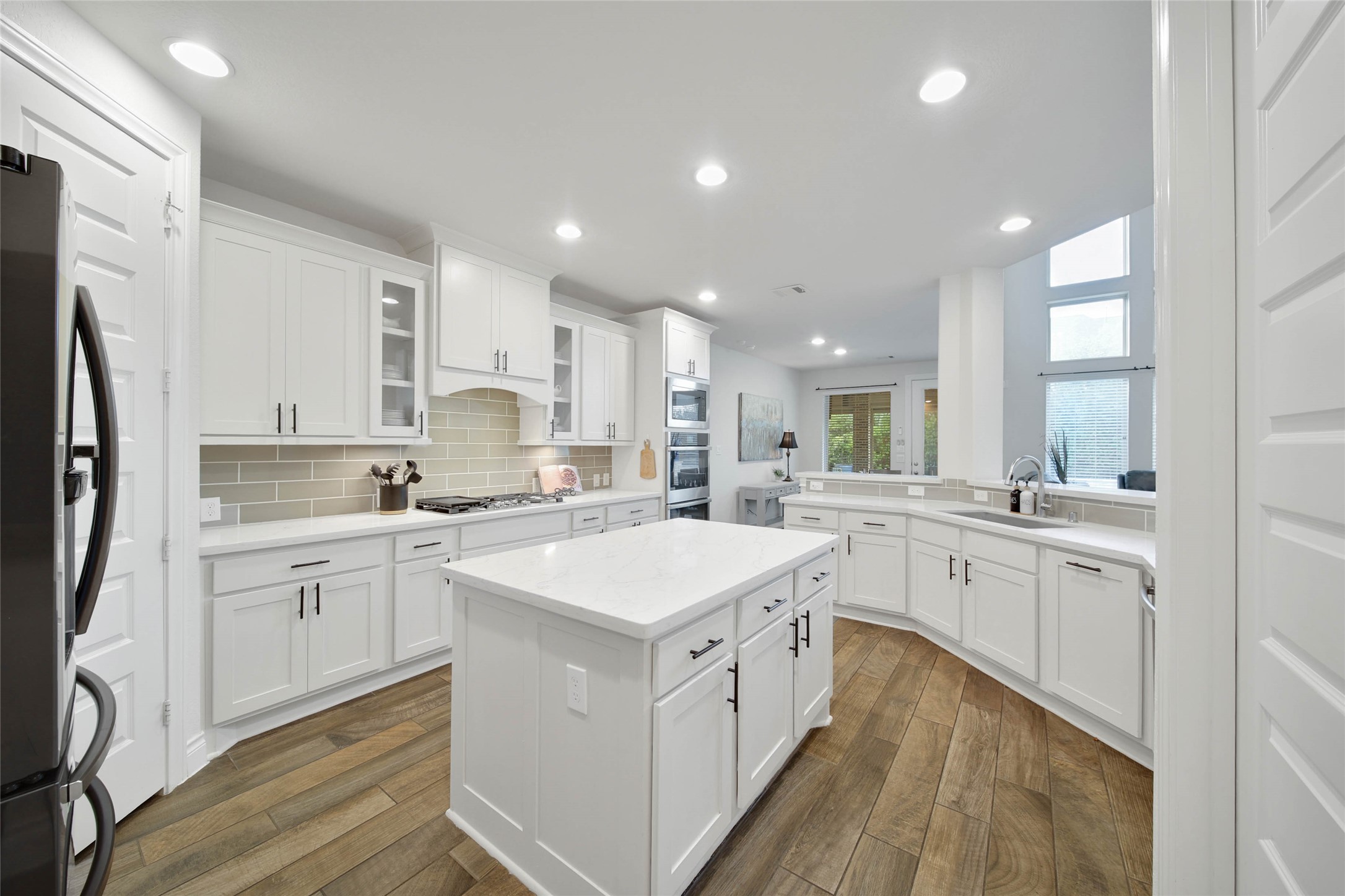 28602 Mountain Timber Court Fulshear, TX 77441 - Photo 16 of 47 The kitchen features a center island perfect for gathering around while providing extra prep space.