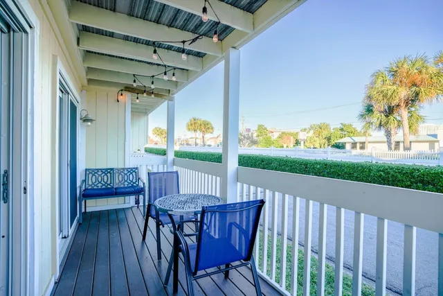 a view of deck with a table and chairs