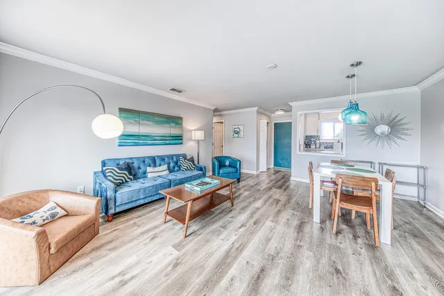 a living room with furniture and a wooden floor