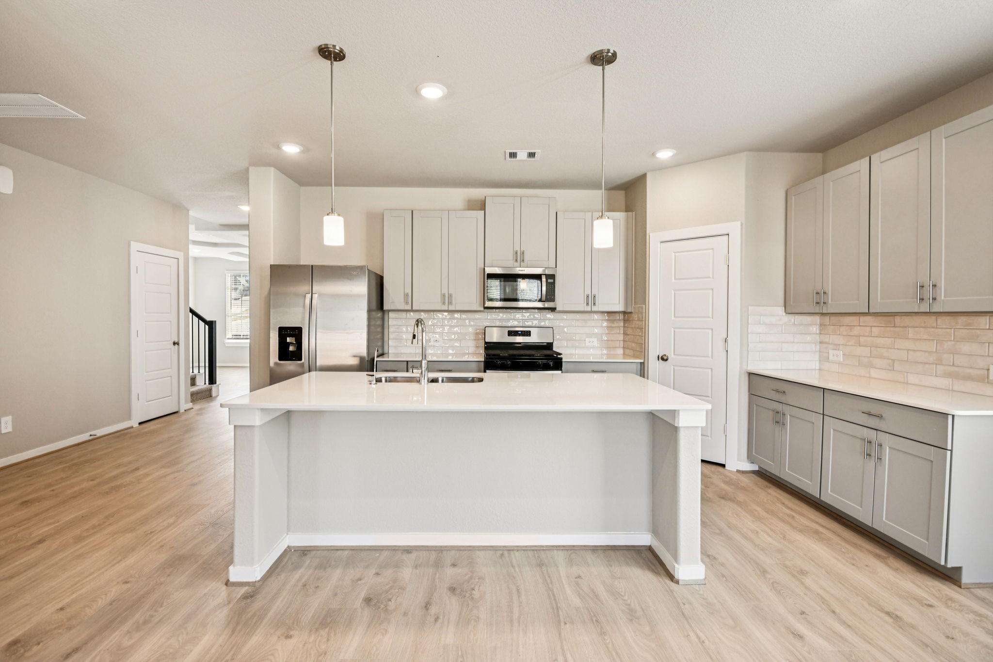 17892 Stone Terrace Montgomery, TX 77316 - Photo 15 of 49 a kitchen with stainless steel appliances sink refrigerator and cabinets
