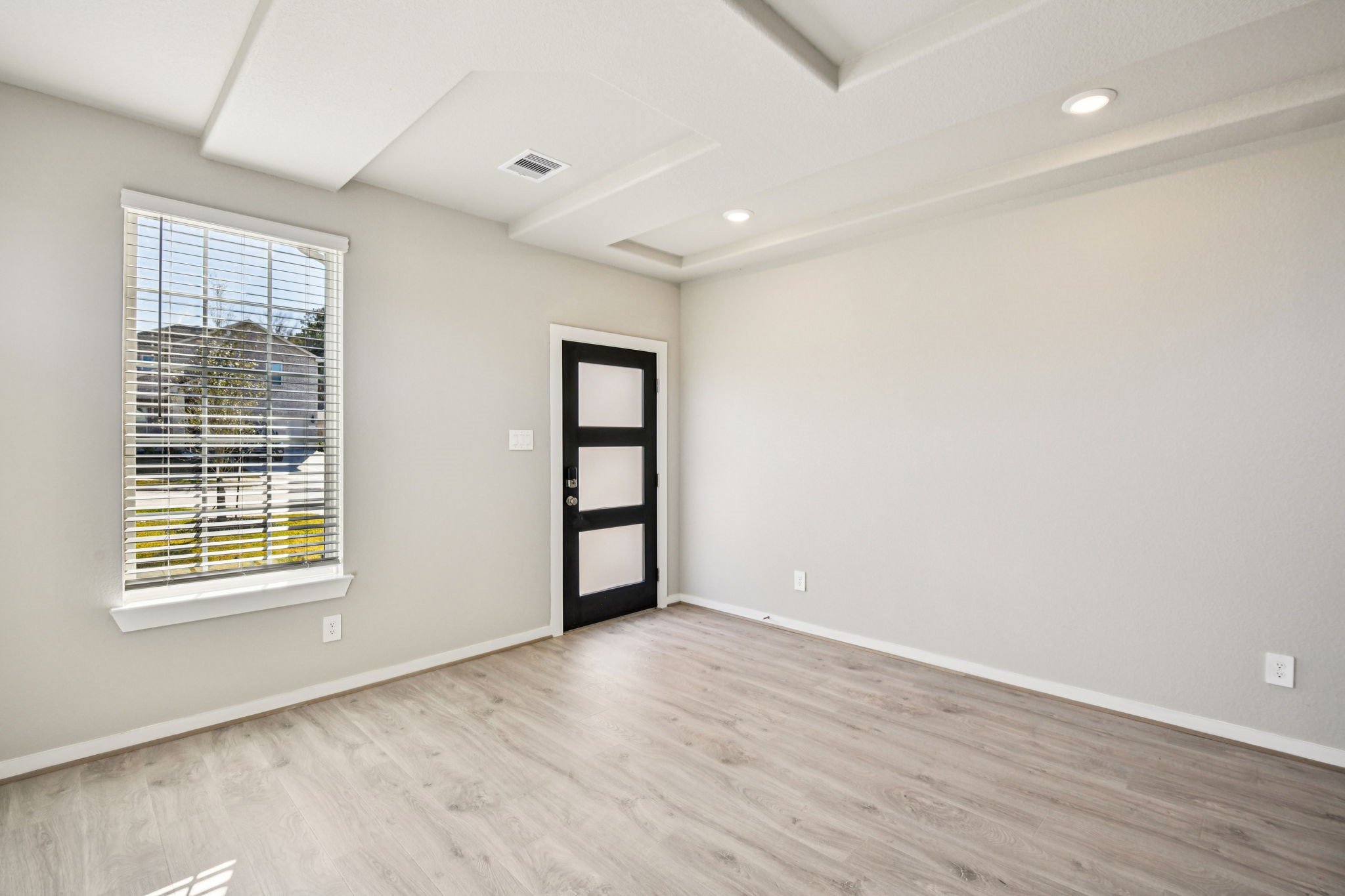 17892 Stone Terrace Montgomery, TX 77316 - Photo 4 of 49 an empty room with wooden floor and windows